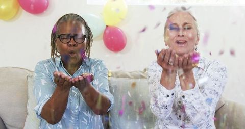 Joyful Elderly Women Celebrating with Confetti