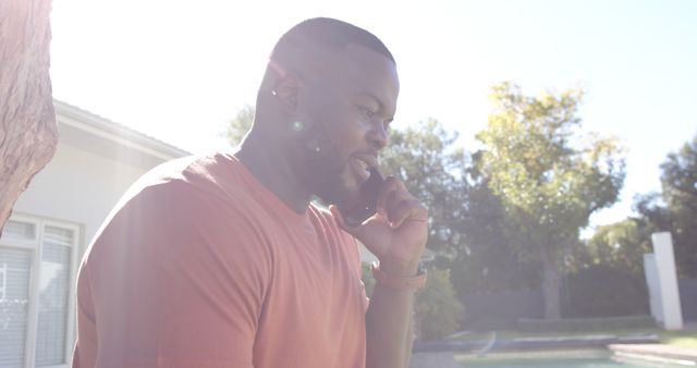 Smiling Man Talking on Phone Outdoors on Sunny Day - Download Free Stock Images Pikwizard.com