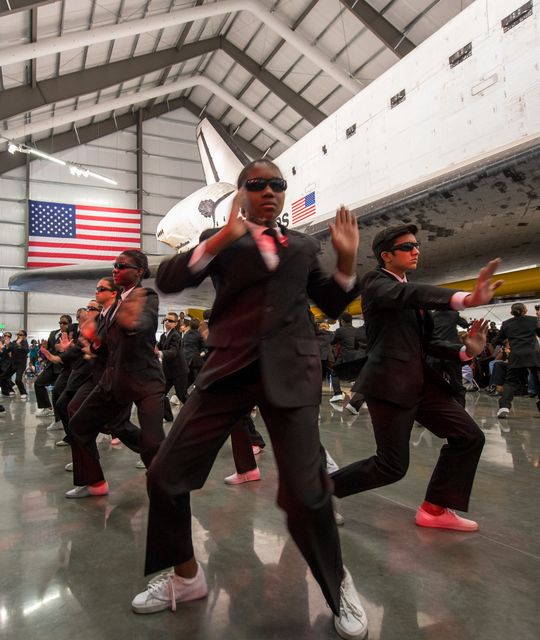 Members of the Debbie Allen Dance Academy perform “Men in Black” choreographed by the legendary Debbie Allen during the grand opening ceremony for the California Science center's Samuel Oschin Space Shuttle Endeavour Display Pavilion, Tuesday, Oct. 30, 2012, in Los Angeles.  Endeavour, built as a replacement for space shuttle Challenger, completed 25 missions, spent 299 days in orbit, and orbited Earth 4,671 times while traveling 122,883,151 miles. Photo Credit: (NASA/Bill Ingalls)