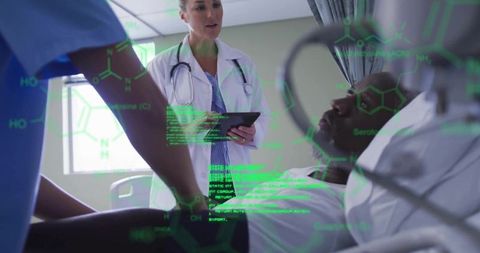 Healthcare professionals using tablet for patient monitoring