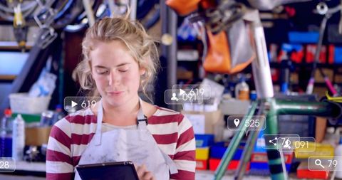 Focused mechanic using tablet in bicycle workshop
