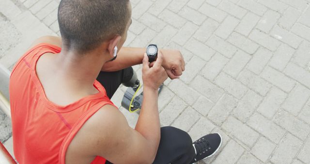 Male Athlete Resting and Checking Smartwatch After Running - Download Free Stock Images Pikwizard.com