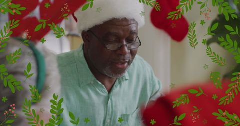 Senior Man in Santa Hat Saying Grace at Christmas Dinner