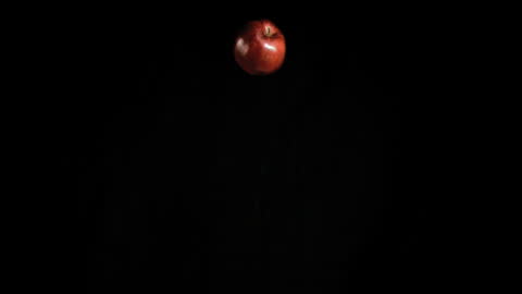 Red Bell Pepper Drop Against Black Background in Slow Motion