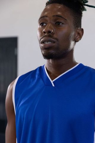 Determined Athlete in Blue Jersey at the Gym