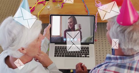 Senior couple in virtual video call celebration with digital communication