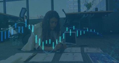 Focused Businesswoman Analyzing Charts in Modern Office