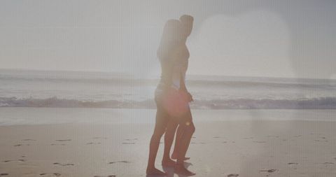 Silhouette of Couple Strolling on Sunny Beach