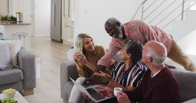 Happy Seniors Socializing in Modern Living Room with Laptop and Coffee - Download Free Stock Images Pikwizard.com