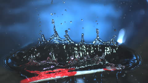 Toothbrush Creating Splash in Water with Droplets