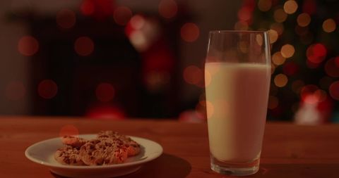 Christmas cookies and milk with festive bokeh lights