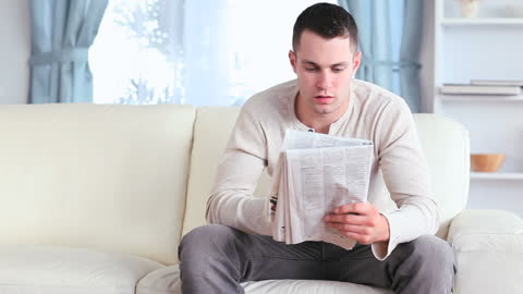 Man Relaxing with Coffee and Newspaper at Home