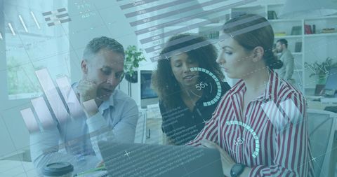 Diverse Team Interacting with Digital Data Visualizations in Modern Office