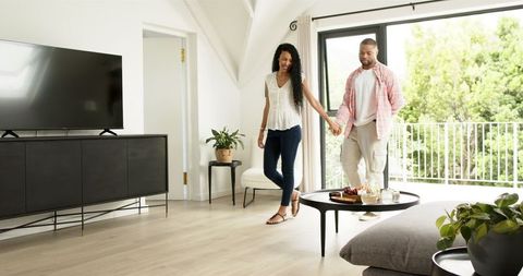 Man proposing to his partner with ring at home