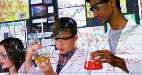 Students conducting colorful chemistry experiment in lab collaborating on stem learning