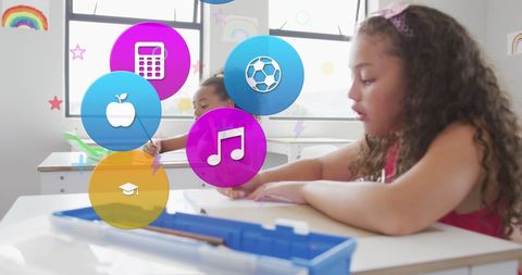 Young schoolgirls are creatively engaged in a classroom, with colorful educational icons like math, soccer, and music displayed thoughtfully, symbolizing the variety of subjects they explore. Use this visual to represent diverse learning environments, progressive education approaches, or educational technology themes in digital media.
