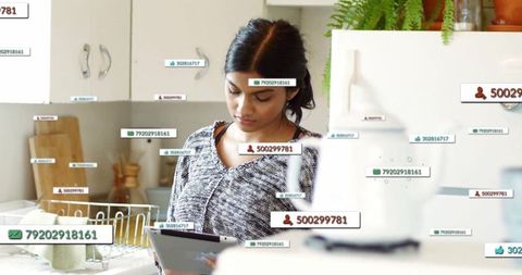 Woman Analyzing Digital Data on Tablet in Kitchen Setting