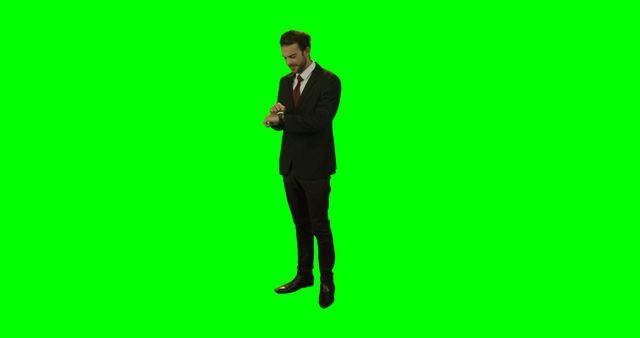 Businessman in Suit Checking Time on Watch against Green Screen - Download Free Stock Images Pikwizard.com
