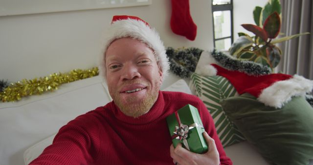 Man Celebrating Christmas Holding Gift Box at Home - Download Free Stock Images Pikwizard.com