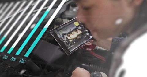 Female Technician Using Tablet for Car Engine Diagnostics with Data Overlay and Analytics