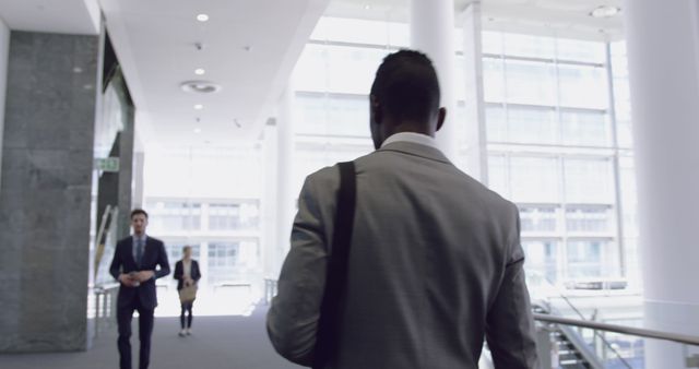 Businessman Walking Through Corporate Lobby in Office - Download Free Stock Images Pikwizard.com