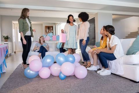 Diverse Female Friends Celebrating With Pastel Balloons and Gifts