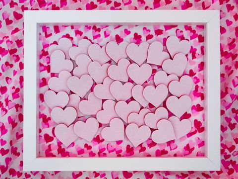Heart-shaped cutouts in white frame on vibrant background