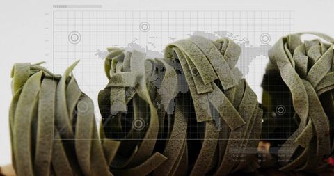 Showing spinach tagliatelle nests aligned with dotted world map overlay and data grid