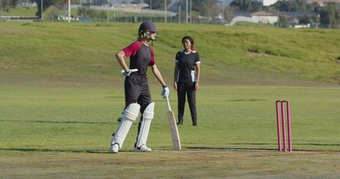 Women Engaged in Cricket Match Highlighting Teamwork in Sports