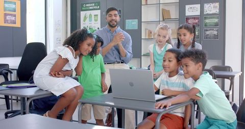 Teacher Leading Engaged Group Learning Around Laptop in Classroom - Download Free Stock Images Pikwizard.com