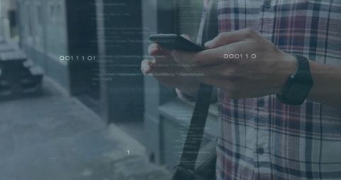 Man Holding Smartphone Viewing Binary Code Overlay in Urban Setting