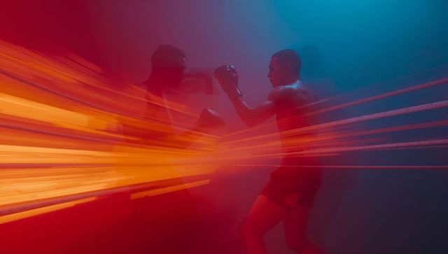 Dynamic boxing match with light effects creating motion impact