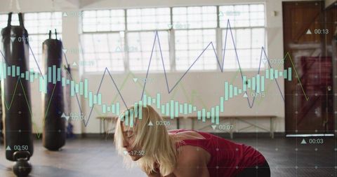 Woman doing core workout in gym with kettlebell and fitness data analytics overlay