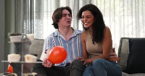 Happy Couple with Balloon Preparing for Birthday Celebration