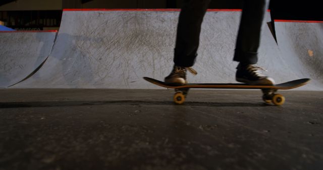 Skilled skateboarder performing a trick on a ramp at the skate park at night. This vibrant, action-focused scene is ideal for use in advertisements, social media posts, or promotional materials related to extreme sports, urban youth culture, or skateboarding events. Perfect for dynamic and energetic campaigns targeting young audiences.