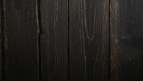 Dark Stained Wood Planks with Sawdust, Knots and Vertical Grain Rustic Texture Background