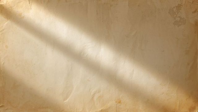 Vintage aged parchment showing diagonal sunlight, creases and foxing for background texture