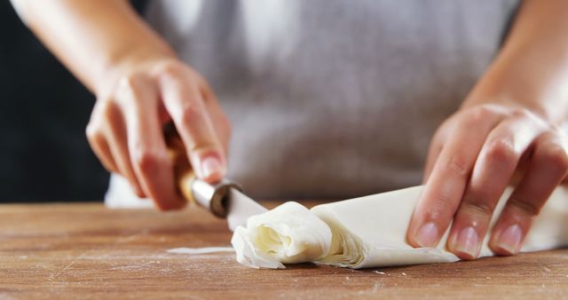 Close-up of hands shaping dough on wooden surface - Download Free Stock Images Pikwizard.com