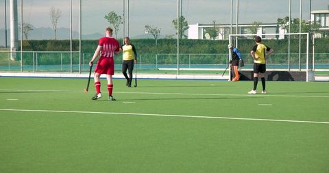 Field Hockey Game on Outdoor Turf with Players in Action