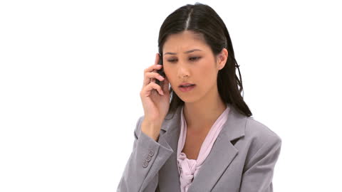 Serious Businesswoman Discussing on Phone in Office Attire