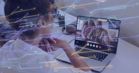 Curly-haired woman video calling family with AR circuit overlays on laptop