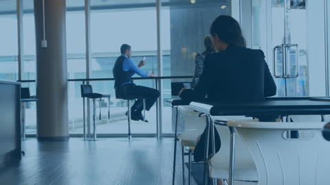 Woman in Modern Office with Filtered Rays of Sunlight, Deep in Thought
