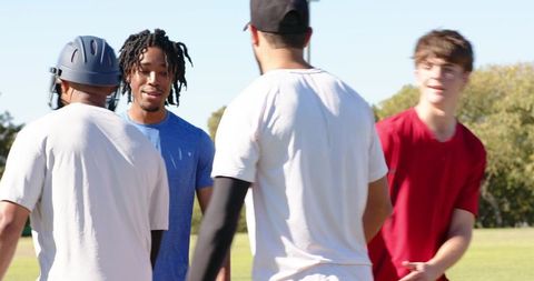 Cricket players greeting teammates on field practicing batting and sportsmanship