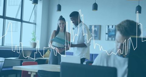 Diverse team discussing data charts in modern office setting