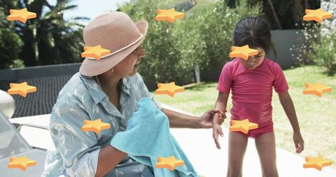 Sun-Hatted Caregiver Holding Towel Helping Child Poolside Backyard Summer Bonding