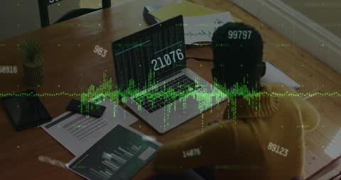 Female Financial Analyst Examining Data on Laptop with Graph Projections