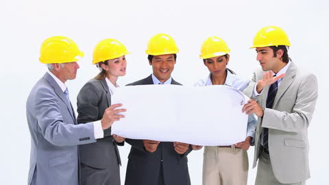 Business Team Analyzing Construction Blueprint in Office