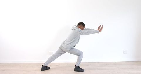 Energetic Young Man in Tracksuit Executing Dynamic Dance Move