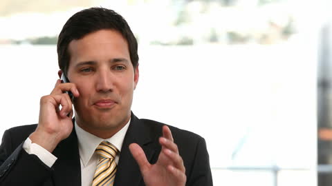Businessman Laughing While on Phone in Office Setting