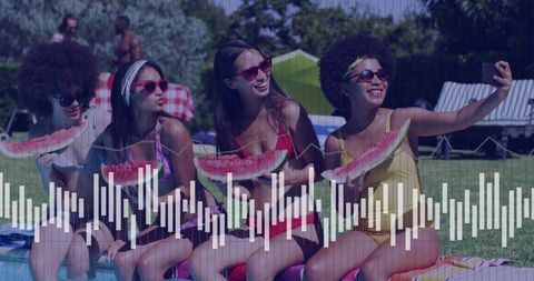 Young women enjoying summer retreat with watermelon and friends